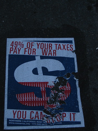 Photograph of a poster on the road at Scott and Haight Streets